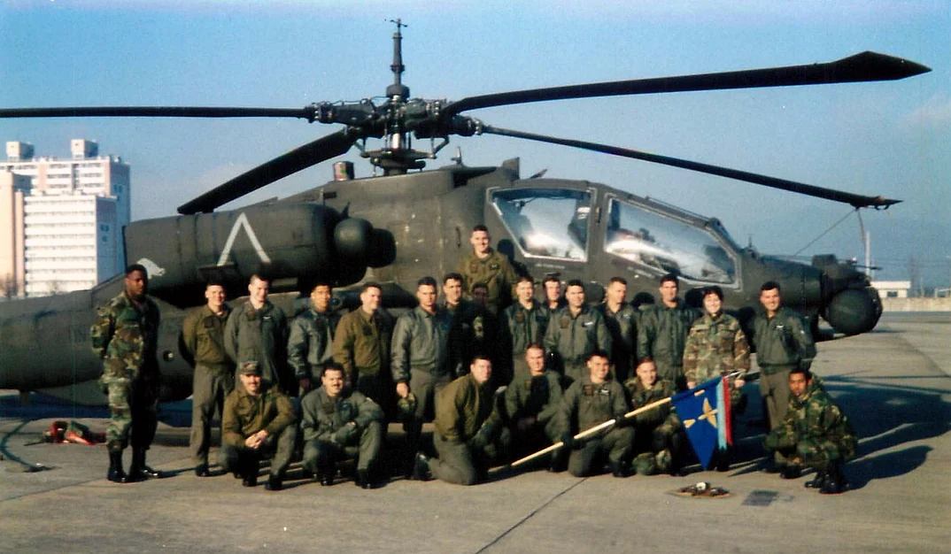 Shannon Huffman Polson: with her Apache company in front of an AH-64 Apache helicopter, 2000